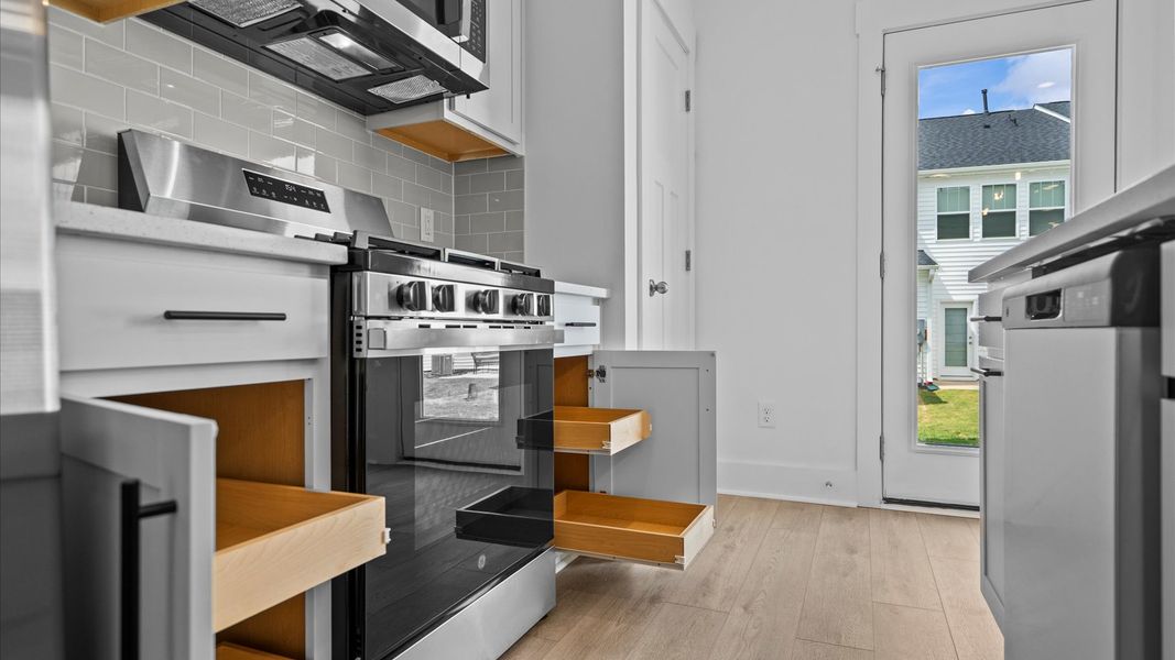 Notable kitchen space with elegant pendant lighting and a large island perfect for entertaining Notable kitchen space with elegant pendant lighting and a large island perfect for entertaining