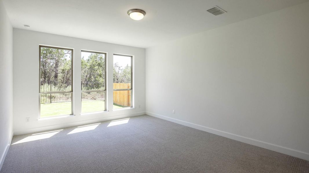 Empty room with carpet flooring and baseboards