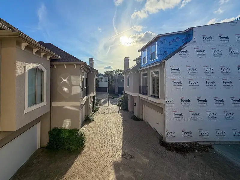 Unobstructed view from the primary bedroom Juliet balcony of the gated enclave toward Dora St.