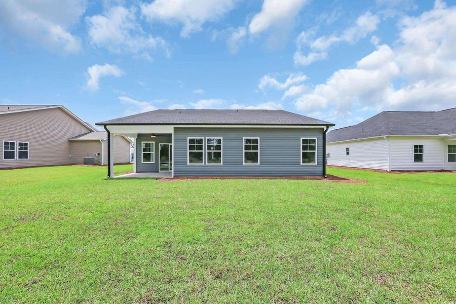 Rear view of property featuring a patio and a yard