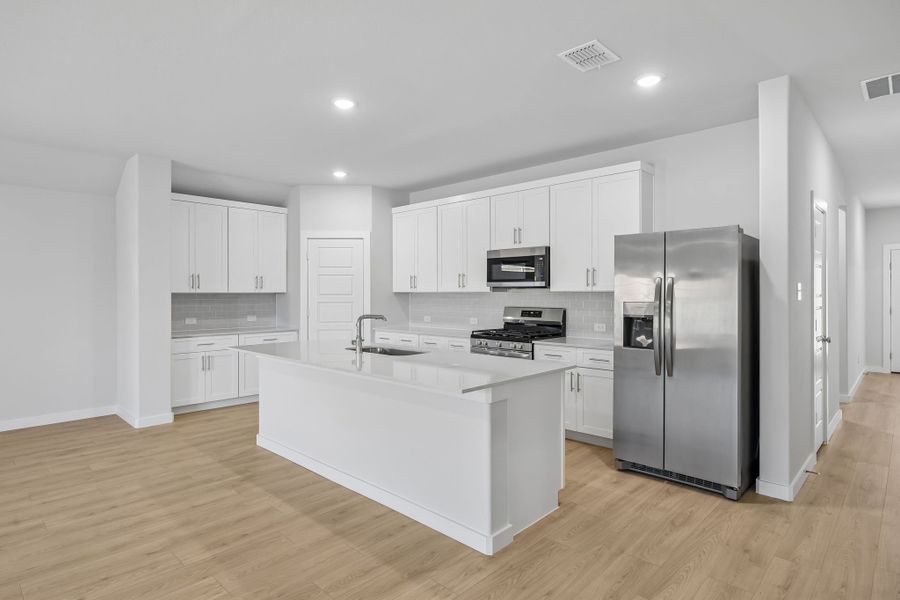 Kitchen in the Heisman home plan by Trophy Signature Homes – REPRESENTATIVE PHOTO Kitchen in the Heisman home plan by Trophy Signature Homes – REPRESENTATIVE PHOTO