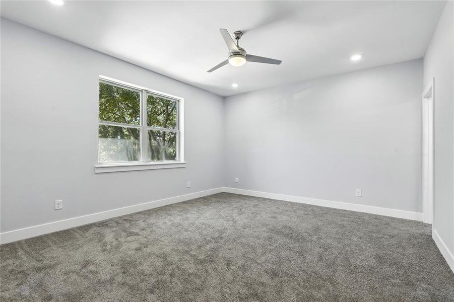 Empty room with carpet flooring, a ceiling fan, and recessed lighting