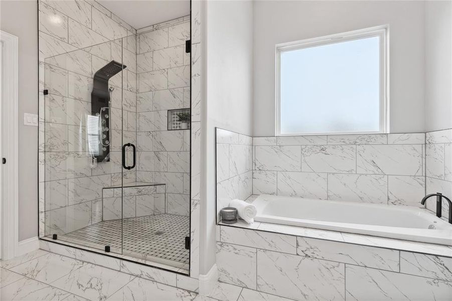 Full bath featuring marble finish floor, a shower stall, and a bath