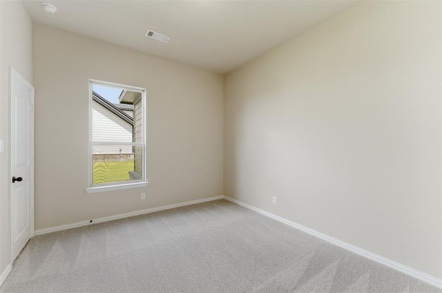 Spare room with light carpet and baseboards Spare room with light carpet and baseboards