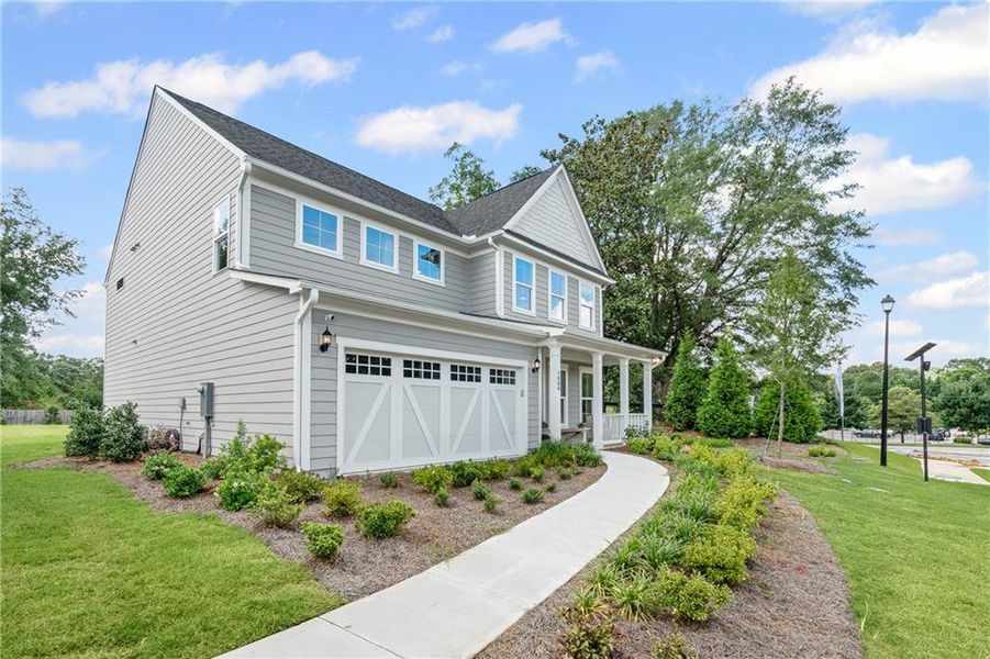Front exterior of a new home in Traditions of Braselton, Jefferson, GA, highlighting curb appeal (Image 21).