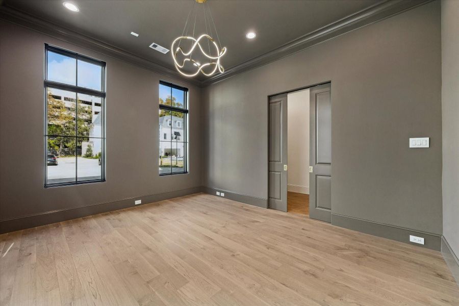 Off the entry is the dedicated office or formal dining. Designer light fixture, spacious closet, and pocket doors complete this space.
