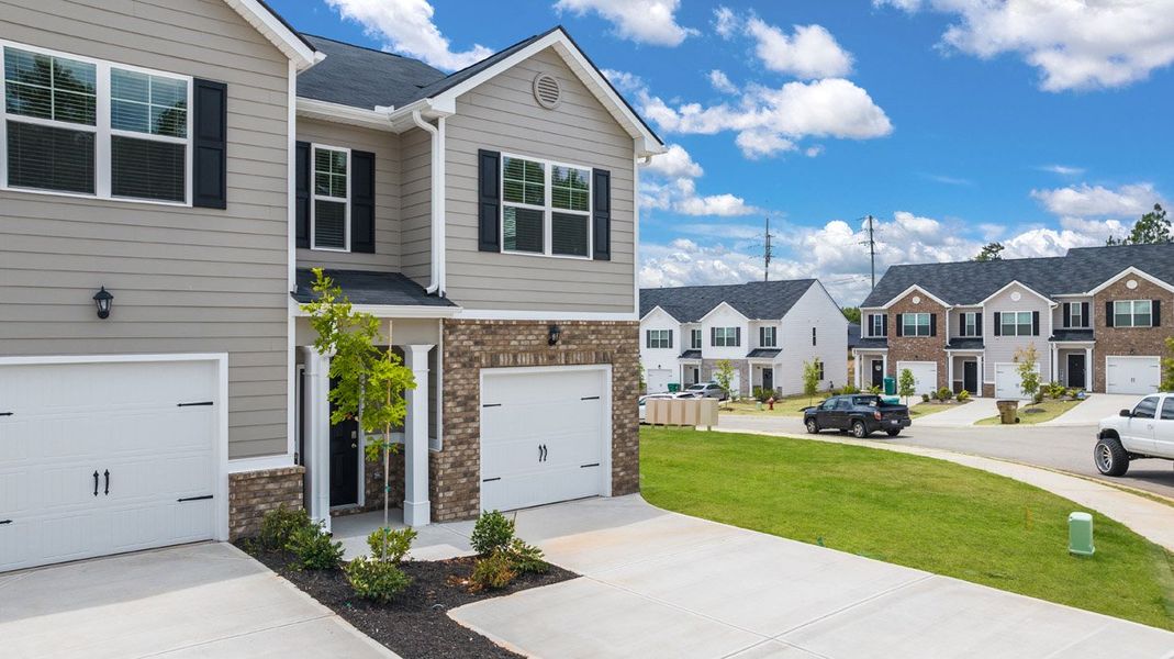 Front exterior of a new home in The Parish at Flat Rock Townhomes, Graniteville, SC, highlighting curb appeal (Image 20). Front exterior of a new home in The Parish at Flat Rock Townhomes, Graniteville, SC, highlighting curb appeal (Image 20).