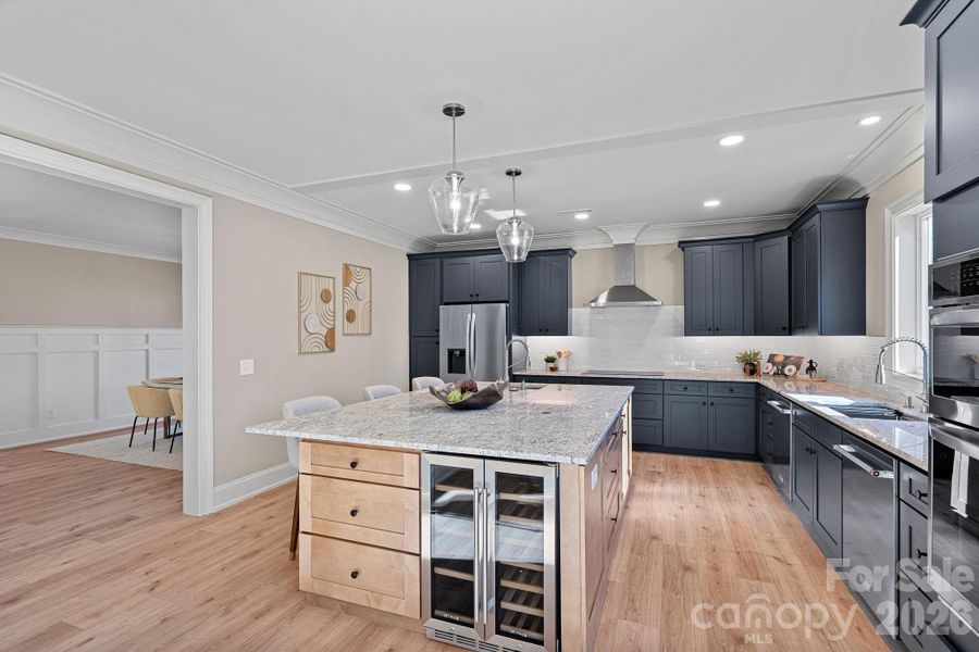 A chef’s Kitchen designed for both everyday living and entertaining, offering dual ovens, dual dishwashers, dual sinks, two refrigerators and a spacious walk-in Pantry.