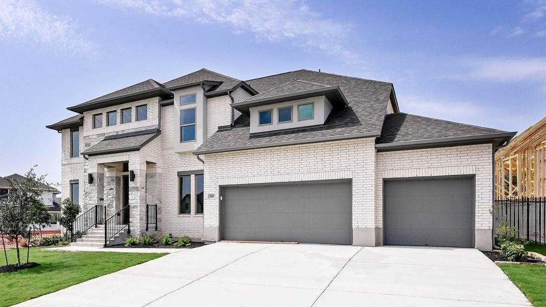 View of front of house with concrete driveway, an attached garage, brick siding, and a shingled roof