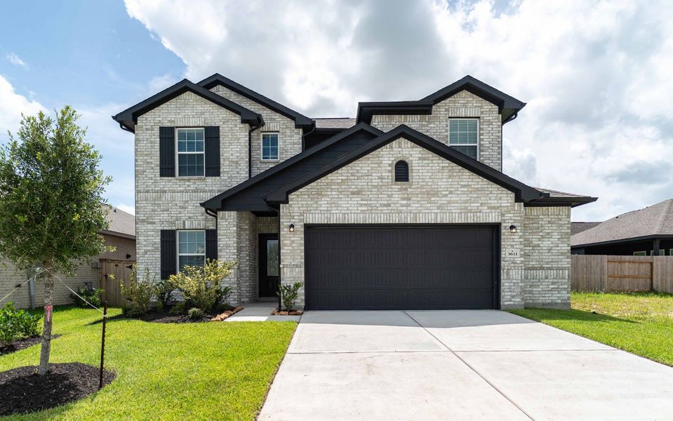Front exterior of a new home in Windrose Green, Angleton, TX, highlighting curb appeal (Image 1). Front exterior of a new home in Windrose Green, Angleton, TX, highlighting curb appeal (Image 1).