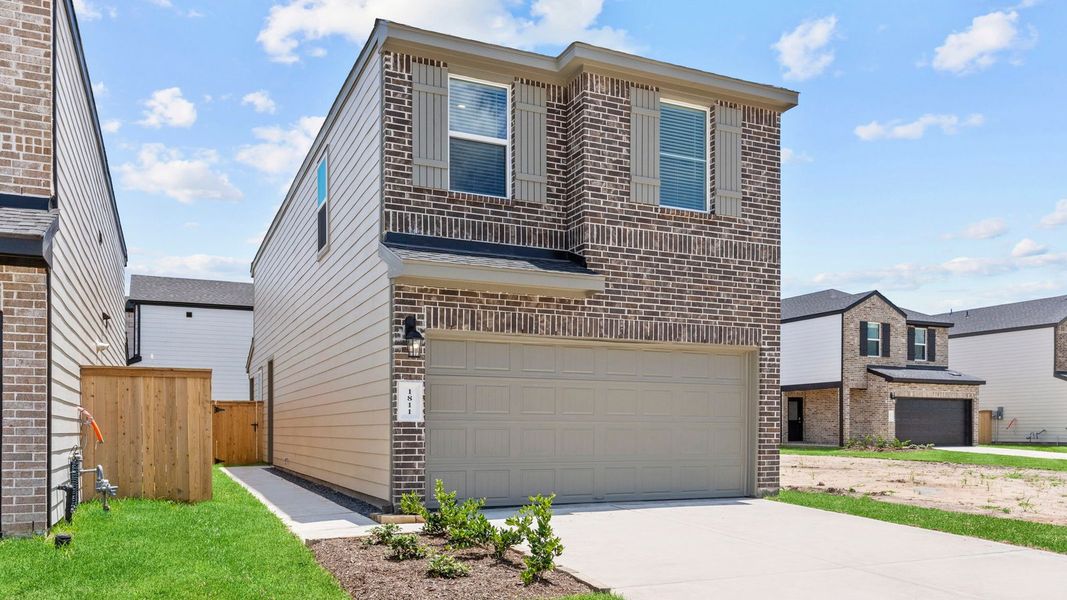Front exterior of a new home in Lexington Village, Missouri City, TX, highlighting curb appeal (Image 1). Front exterior of a new home in Lexington Village, Missouri City, TX, highlighting curb appeal (Image 1).