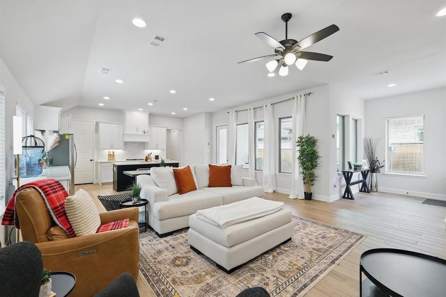 Living area featuring visible vents, recessed lighting, light wood-type flooring, and ceiling fan