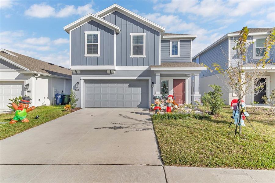 Front exterior of a new home in Peace Creek Reserve: Legacy Collection, Winter Haven, FL, highlighting curb appeal (Image 2). Front exterior of a new home in Peace Creek Reserve: Legacy Collection, Winter Haven, FL, highlighting curb appeal (Image 2).
