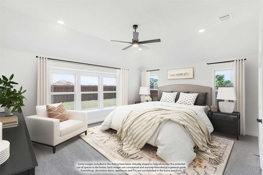 Bedroom with ceiling fan, carpet flooring, large windows, and neutral decor including a sitting chair and area rug Bedroom with ceiling fan, carpet flooring, large windows, and neutral decor including a sitting chair and area rug