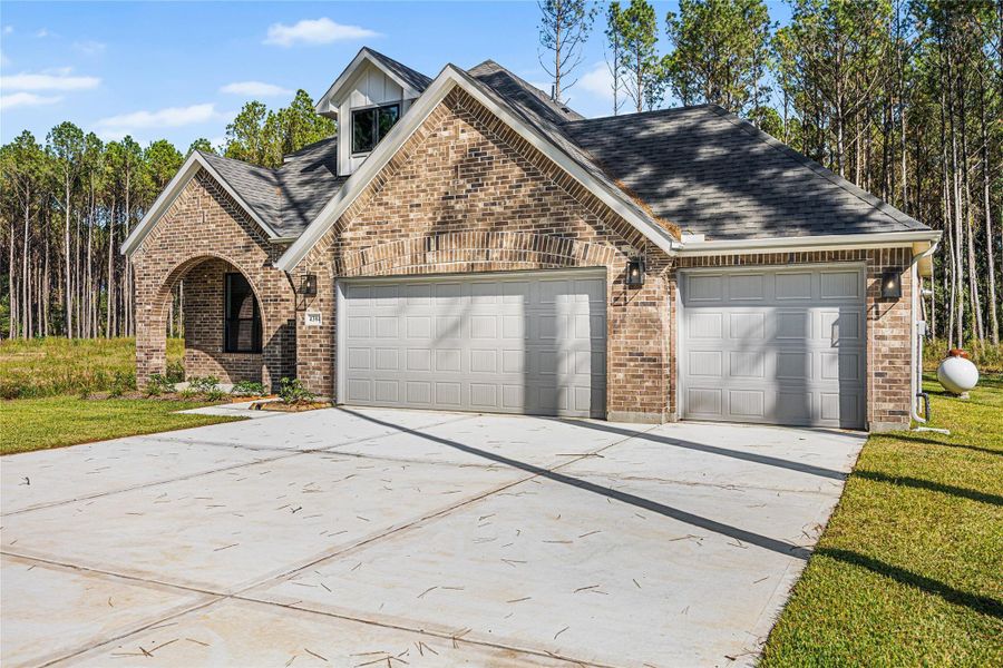 Front exterior of a new home in Encino Estates, Dayton, TX, highlighting curb appeal (Image 1). Front exterior of a new home in Encino Estates, Dayton, TX, highlighting curb appeal (Image 1).