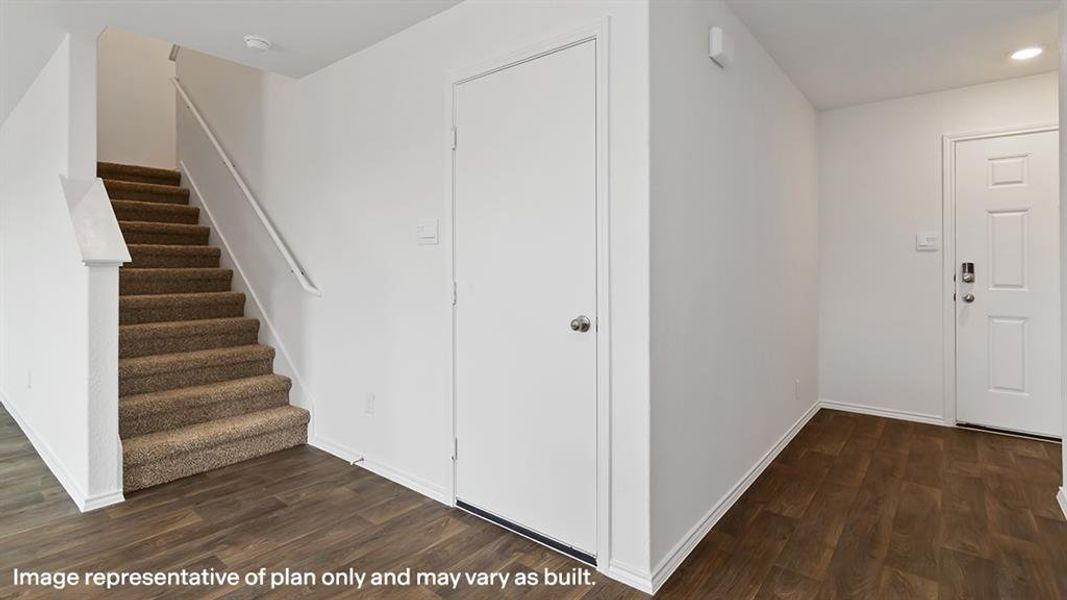 Entrance foyer featuring dark wood-type flooring and stairs