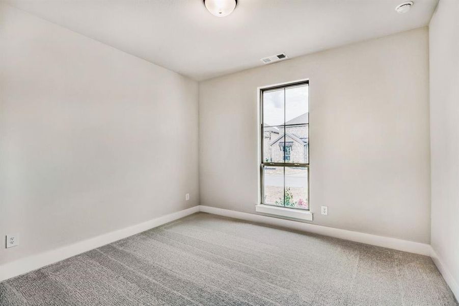 Carpeted empty room featuring baseboards