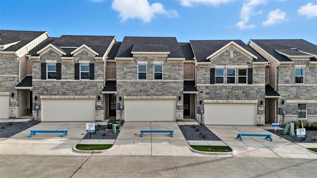 Craftsman-style home with concrete driveway, stone siding, and roof with shingles Craftsman-style home with concrete driveway, stone siding, and roof with shingles