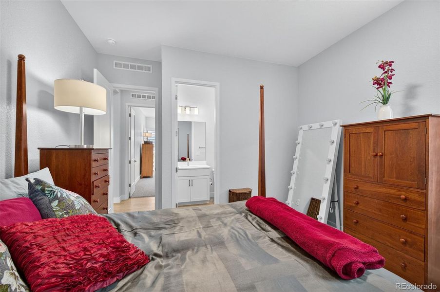 Bedroom 3 (Angle 1) – Inviting additional bedroom with warm natural light and direct access to an adjoining full bathroom.