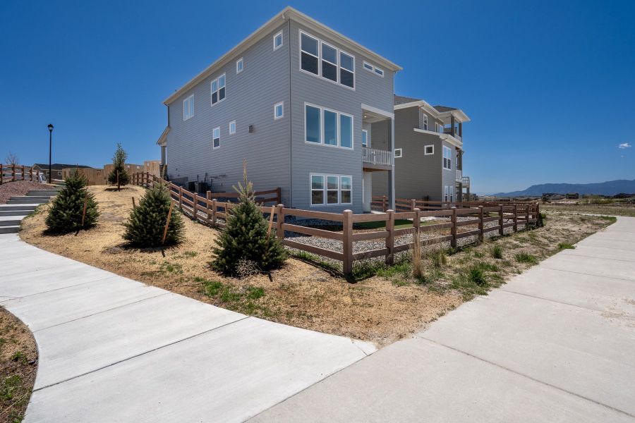 Exterior details and patio area of a home in Revel Crossing at Wolf Ranch - The Panorama Collection, Colorado Springs (Image 4).