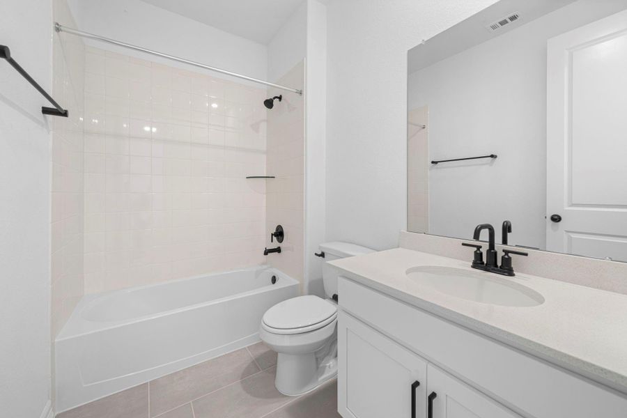 The secondary bath features tile flooring, white cabinetry and light countertops and a shower/tub combo. Perfect for accommodating any visiting family and friends. The secondary bath features tile flooring, white cabinetry and light countertops and a shower/tub combo. Perfect for accommodating any visiting family and friends.