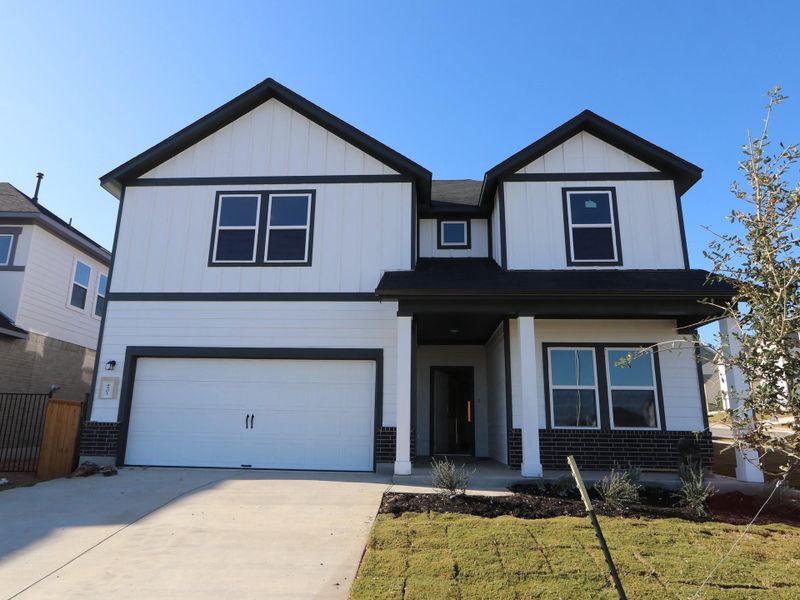 Front exterior of a new home in Cascades at Onion Creek, Austin, TX, highlighting curb appeal (Image 1). Front exterior of a new home in Cascades at Onion Creek, Austin, TX, highlighting curb appeal (Image 1).