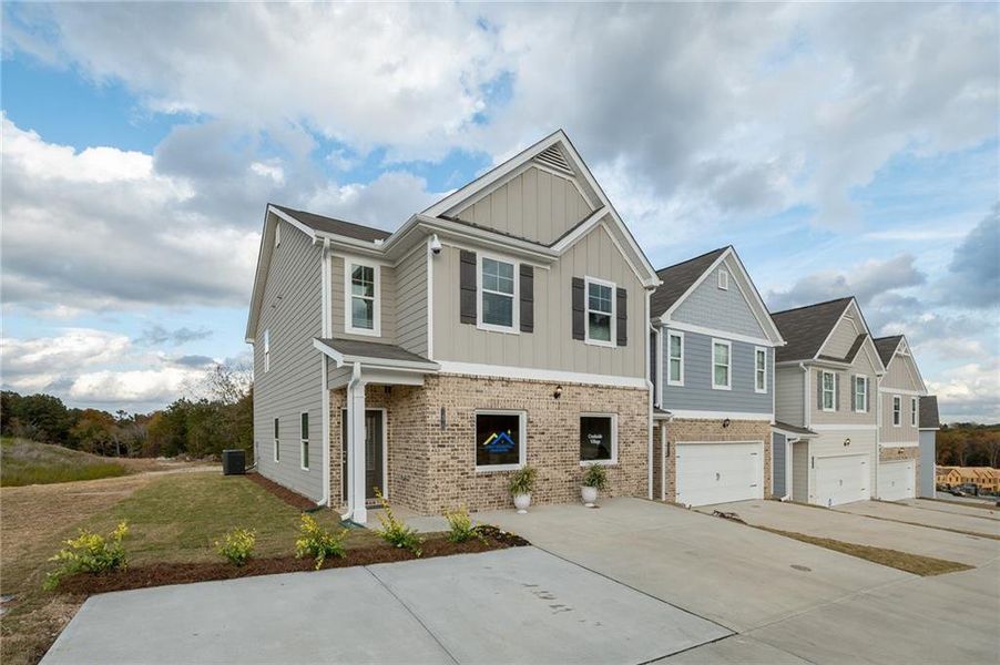 Front exterior of a new home in Creekside Village, Lithonia, GA, highlighting curb appeal (Image 22).