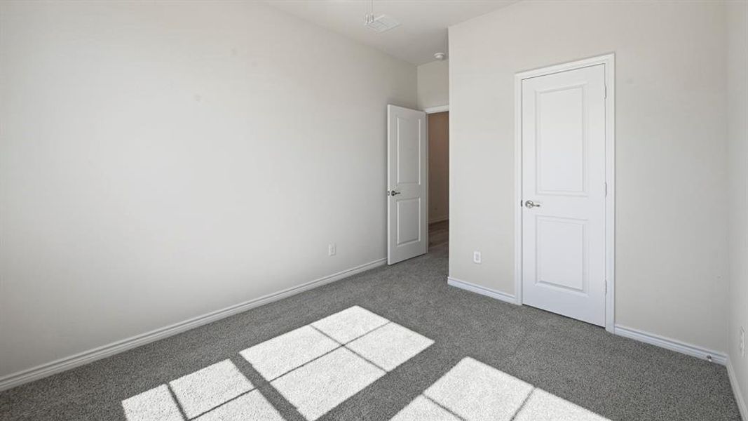 Unfurnished bedroom with carpet floors and baseboards Unfurnished bedroom with carpet floors and baseboards
