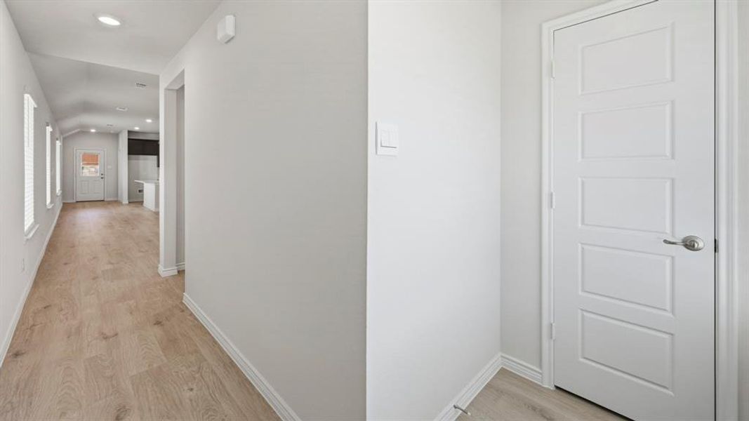 Hall featuring light wood finished floors and recessed lighting