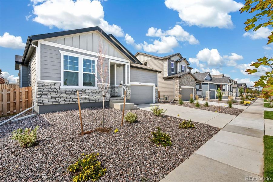 Front exterior of a new home in Turnberry, Commerce City, CO, highlighting curb appeal (Image 19).