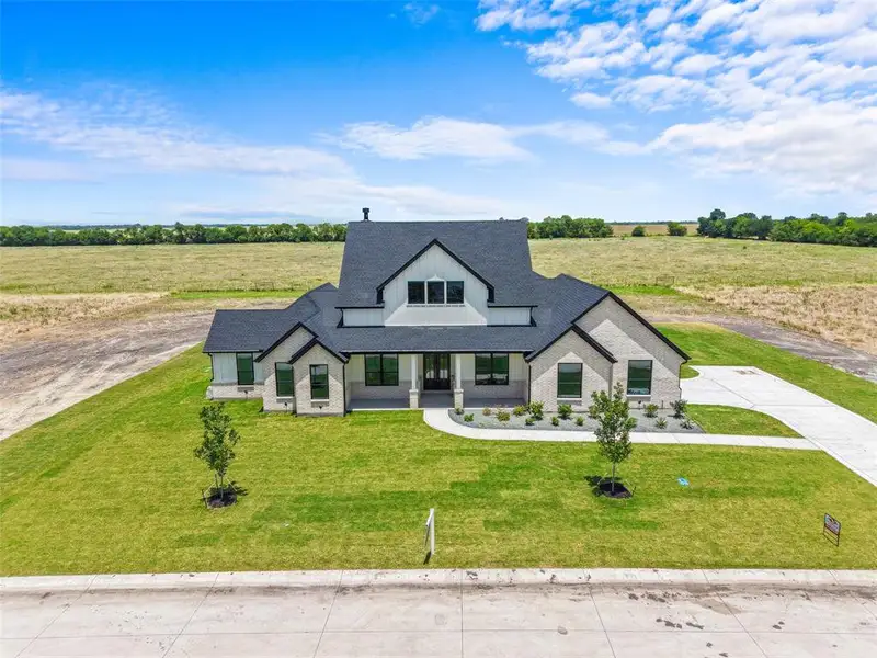 Front exterior of a new home in , Caddo Mills, TX, highlighting curb appeal (Image 27).