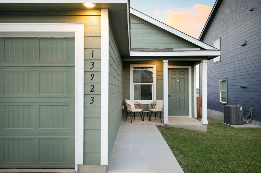 Exterior entry at dusk with a porch and a yard Exterior entry at dusk with a porch and a yard