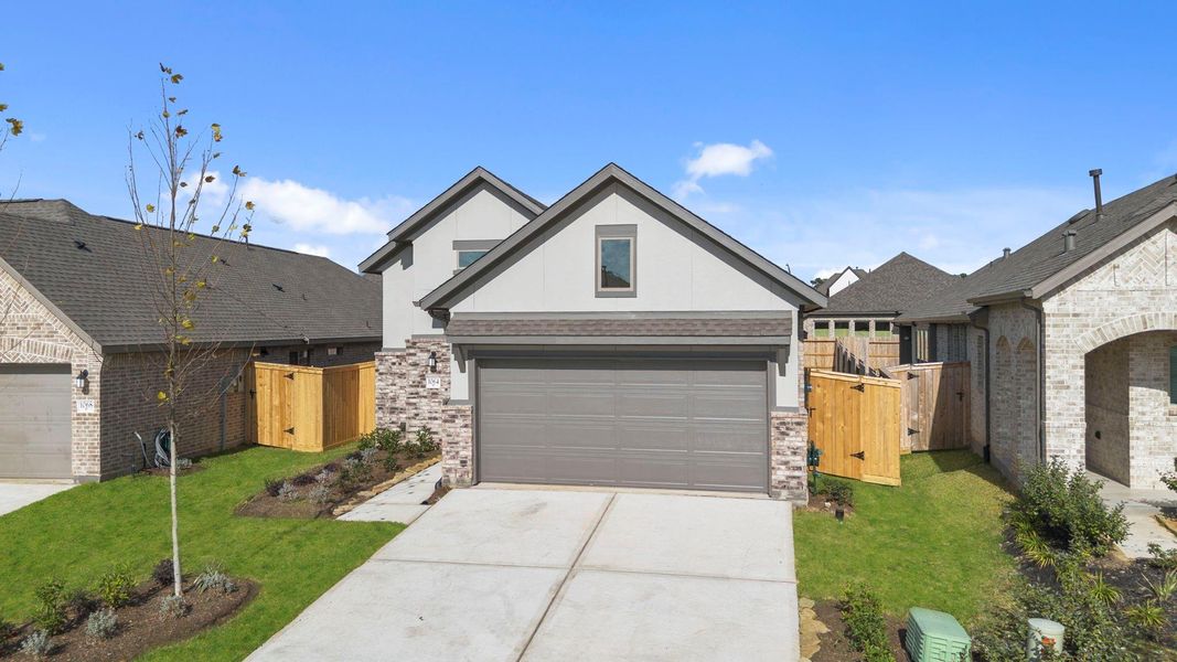 Front exterior of a new home in Grand Central Park, Conroe, TX, highlighting curb appeal (Image 19).