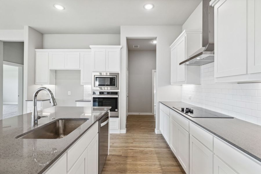 Kitchen in the Bowie home plan by Trophy Signature Homes – REPRESENTATIVE PHOTO Kitchen in the Bowie home plan by Trophy Signature Homes – REPRESENTATIVE PHOTO