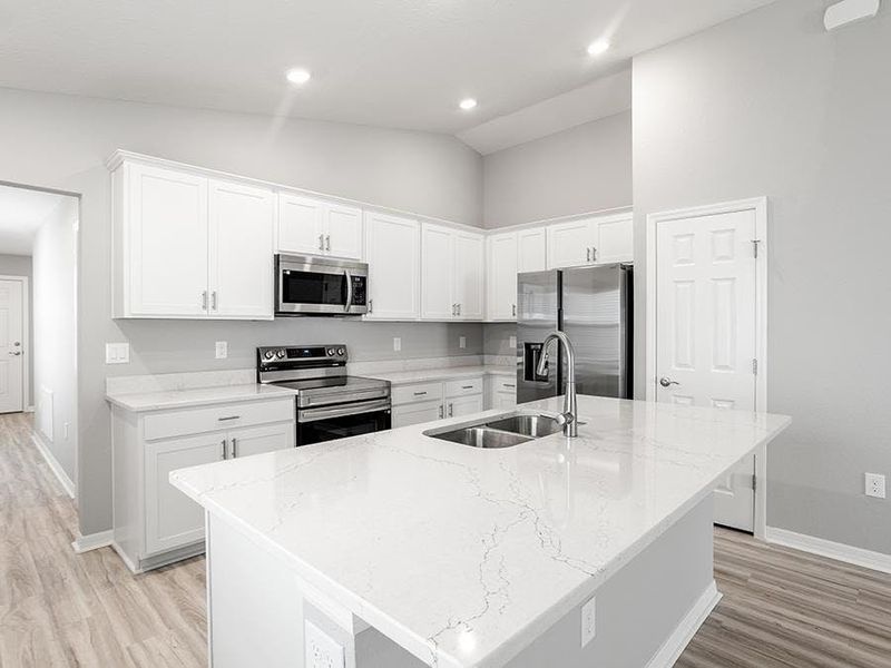 Your new kitchen lives large with an island, ample counter space, and a pantry - Ashlyn by Highland Homes