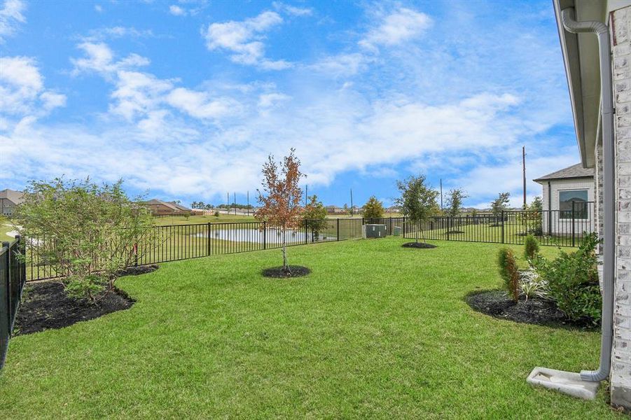 Backyard retreat, offering an abundance of space for kids to play and explore. The possibilities are endless in this outdoor haven, where the joy of open-air activities and family gatherings awaits. Sample photo of completed home with similar floor plan. Actual colors and selections may vary.