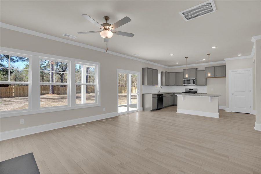 This airy open-concept living area and kitchen off This airy open-concept living area and kitchen off