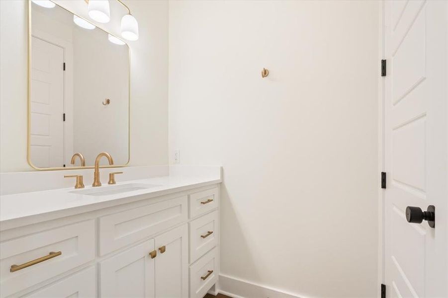 Bathroom featuring vanity and baseboards