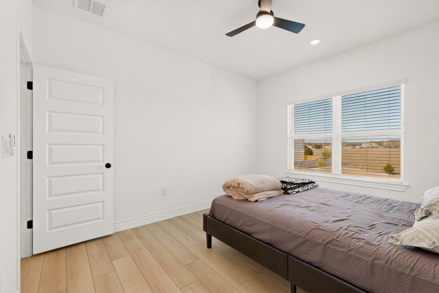 Bedroom featuring ceiling fan, light wood-style flooring, and recessed lighting