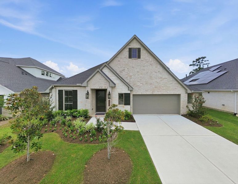 Front exterior of a new home in Audubon 60′, Magnolia, TX, highlighting curb appeal (Image 2). Front exterior of a new home in Audubon 60′, Magnolia, TX, highlighting curb appeal (Image 2).