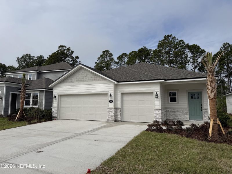 Front exterior of a new home in Reserve East, Flagler Beach, FL, highlighting curb appeal (Image 28).