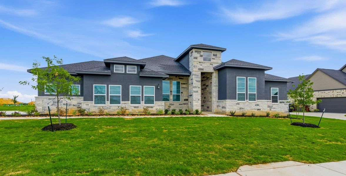 Front exterior of a new home in Sienna Lakes, San Antonio, TX, highlighting curb appeal (Image 2). Front exterior of a new home in Sienna Lakes, San Antonio, TX, highlighting curb appeal (Image 2).