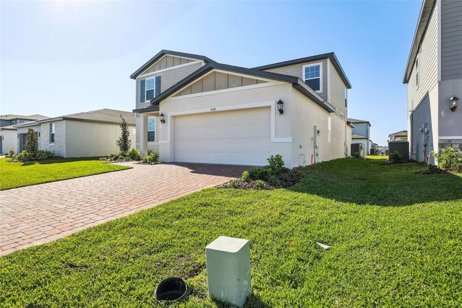 Front exterior of a new home in The Meadow at Crossprairie, St. Cloud, FL, highlighting curb appeal (Image 25).