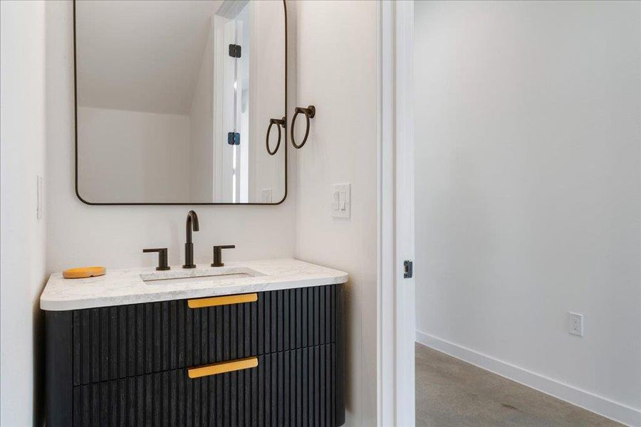 Bathroom featuring vanity and concrete floors