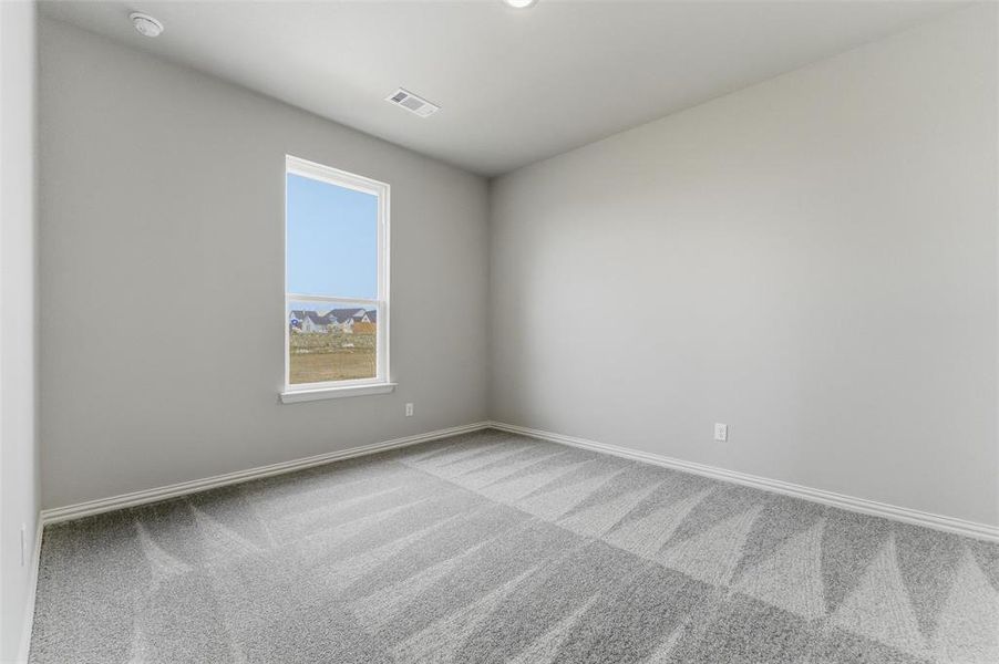 Carpeted empty room with baseboards