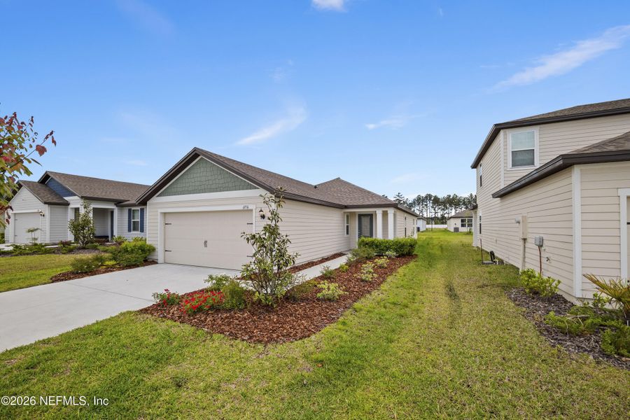Front exterior of a new home in Westport Landing, Jacksonville, FL, highlighting curb appeal (Image 24).