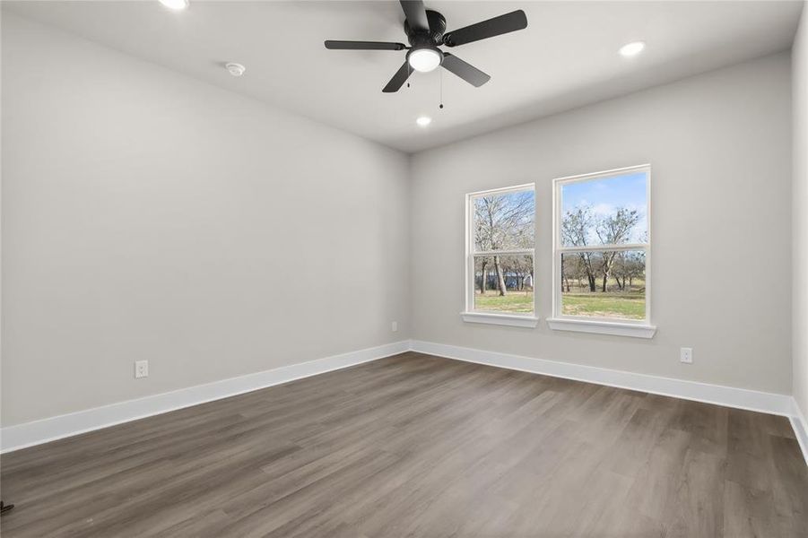 Spare room with dark hardwood / wood-style floors and ceiling fan