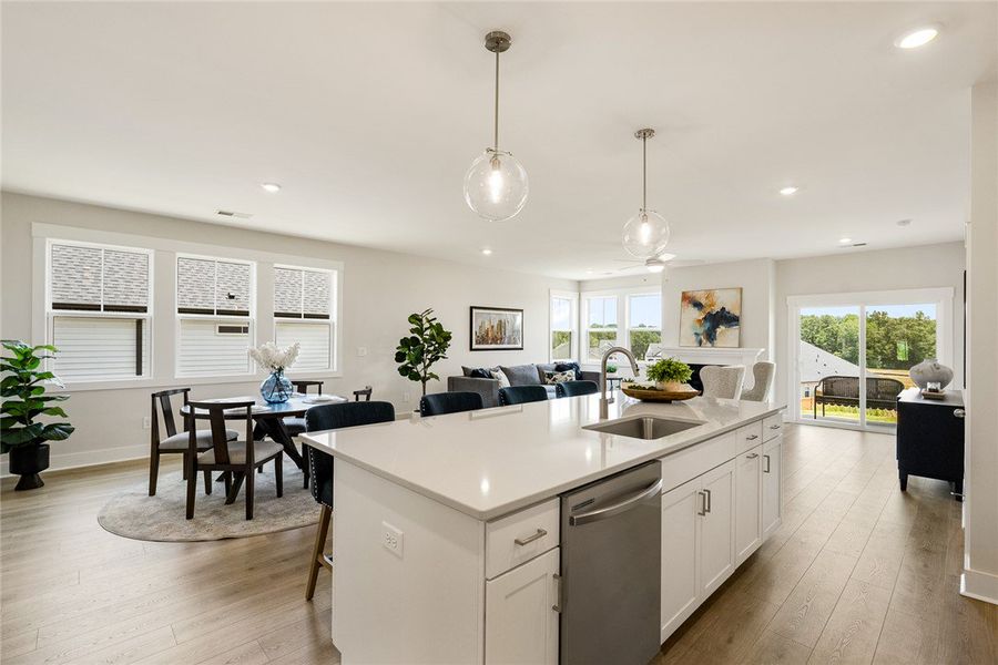 An open floorplan seamlessly connects a sleek kitc An open floorplan seamlessly connects a sleek kitc