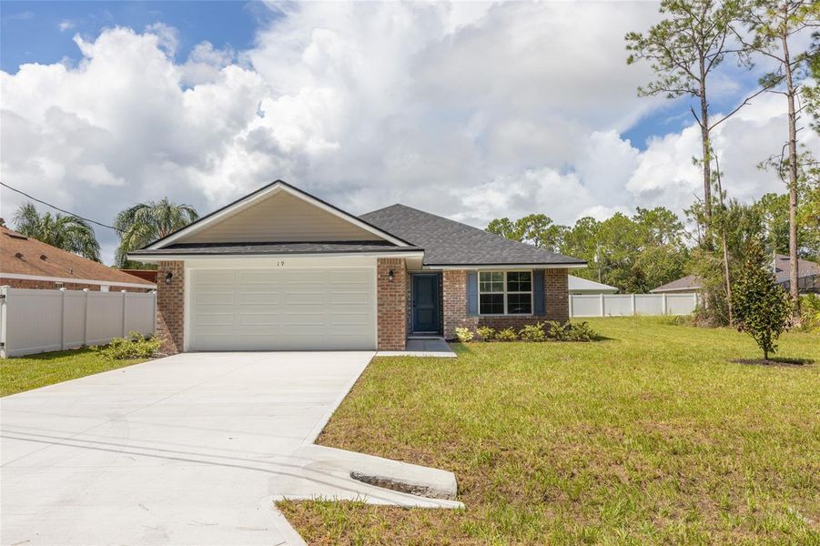 Front exterior of a new home in Palm Coast, Palm Coast, FL, highlighting curb appeal (Image 1). Front exterior of a new home in Palm Coast, Palm Coast, FL, highlighting curb appeal (Image 1).