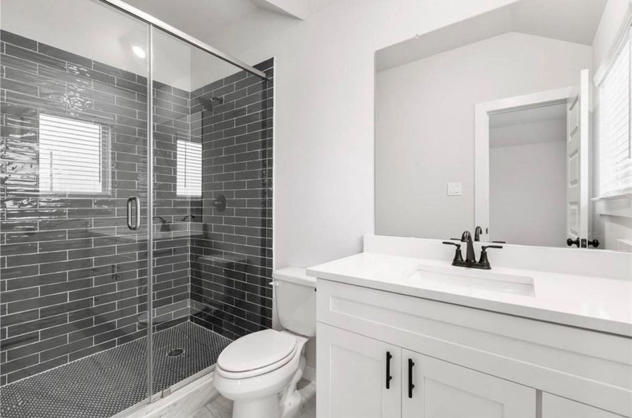 Modern bathroom with sleek tile shower, stylish vanity, and natural light Modern bathroom with sleek tile shower, stylish vanity, and natural light